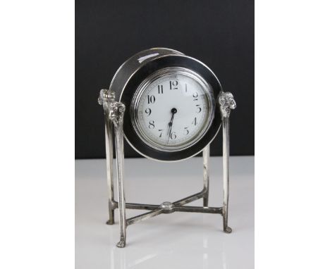 French Empire Style Mantle Clock contained within a Silver Plated Case raised on square pillar supports with Ram's Head Finia