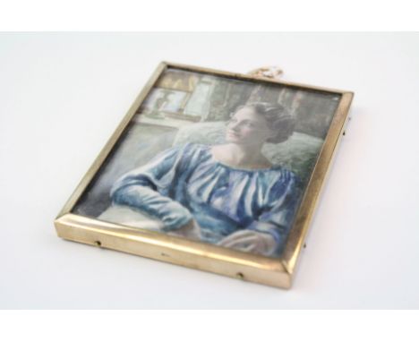 A miniature portrait painted on an ivory panel within a yellow metal frame.