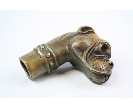 A bronze walking stick handle in the form of a boxer dog.