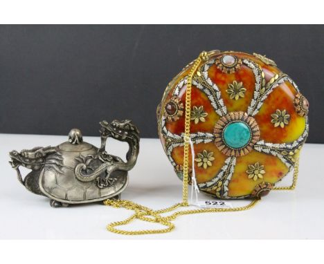 A faux stone purse with brass inlay and set with polished stones,and a white metal dragon teapot with charaters marks to unde