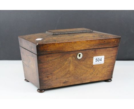 A 19th century rosewood sarcophagus tea caddy with fitted interior.