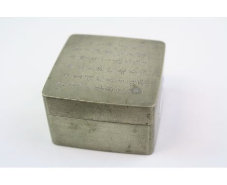 A vintage chinese trinket box with chinese script to the lid.