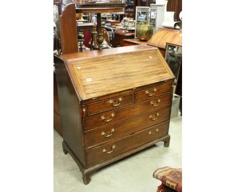 George III Mahogany Bureau, the fall front opening to reveal a fitted interior with shell inlay, over two short and three lon