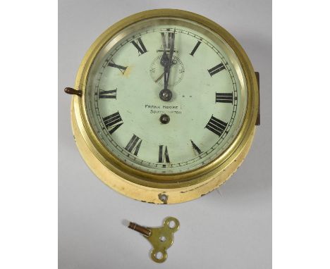 An Early 20th Century Circular Brass Cased Bulkhead Clock, the dial signed "Frank Moore, Southampton", Movement Requires Atte