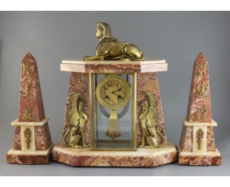 An early 20th century French ormolu and marble Egyptian revival clock garniture, with portico style clock surmounted with a m