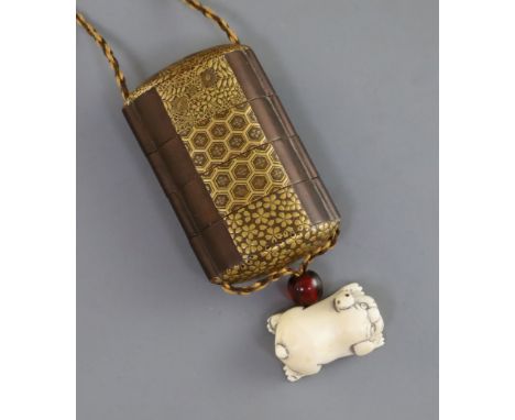 A Japanese three case gold lacquer inro, 19th century, the front of each section decorated with varying brocade patterns, tog