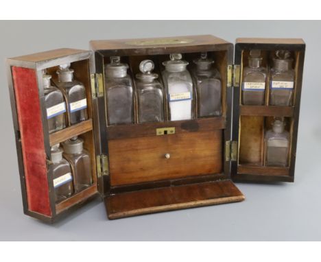 An early 19th century brass mounted mahogany apothecary chest, fitted with eleven (ex. twelve) glass jars, scales and other a