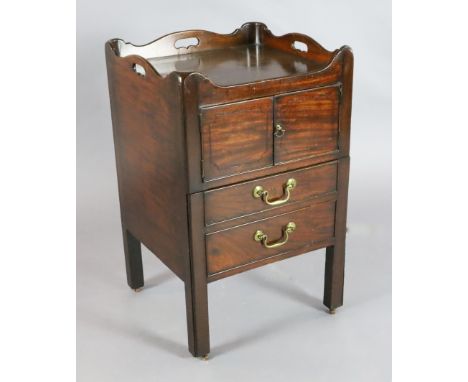 A George III ebony strung mahogany tray top commode, with two doors and base drawer, on squared legs with fitted brass castor