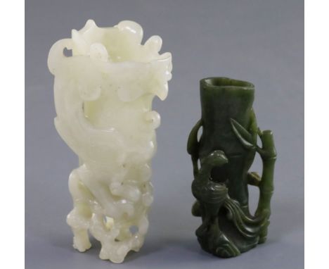 A Chinese archaistic white jade rhyton and a spinach green jade vase, 18th/19th century, the phoenix standing upon rootwood, 