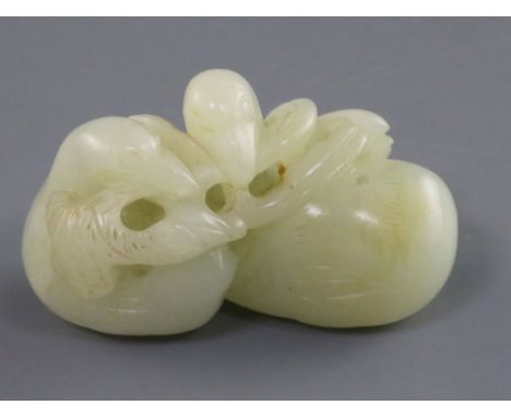 A Chinese pale celadon jade carving of two ducks biting lotus, 19th century the stone of good even tone with a faint russet s