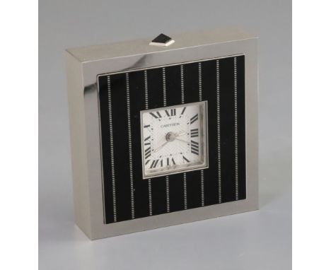 A Cartier black enamel and steel cased timepiece, with silvered Roman dial, number 145450GD/2747, height 3.75in.