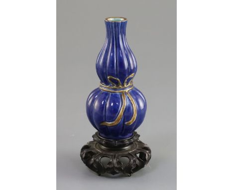 A small Chinese blue glazed double gourd vase, 18th/19th century, lobed and with a gilt ribbon tied around the waist, turquoi