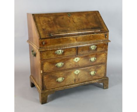 A mid 18th century featherbanded walnut bureau, the fall enclosing central cupboard., 'secret slides', pigeon holes, drawers 