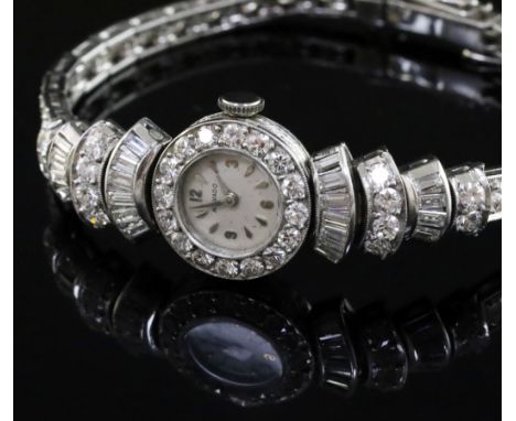 A lady's 1960's Art Deco style platinum and diamond set Movado manual wind cocktail watch, the bezel, fan shaped lugs and bra