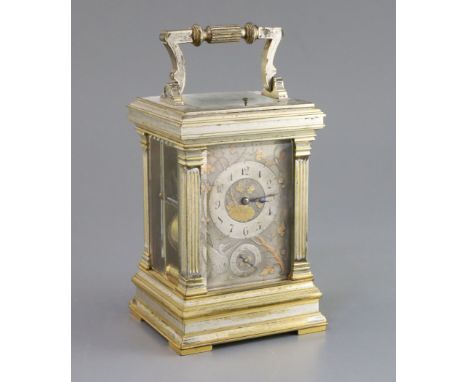 An early 20th century French silvered and parcel gilt hour repeating carriage alarum clock, in floral engraved architectural 