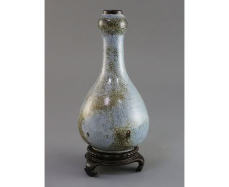 A Chinese Jun type garlic neck vase, Qing dynasty, Shiwan Kilns, the blue mottled glaze with brown speckling, unglazed foot, 