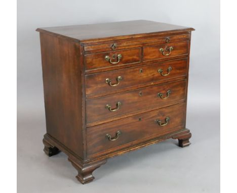 A George III mahogany chest, with brushing slide, two short and three graduated long drawers, on ogee bracket feet, W.2ft 10i