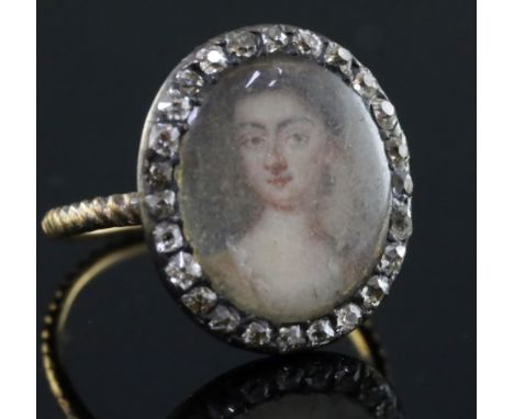 A George III gold and diamond set oval portrait ring, painted with the bust of a lady, size G/H.