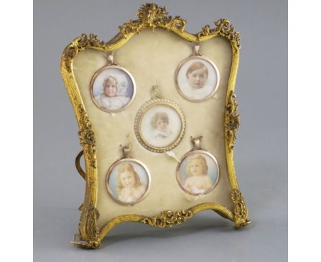 An early 20th century set of five painted miniatures of infants, one in split pearl set gold frame, the others in plain gold 