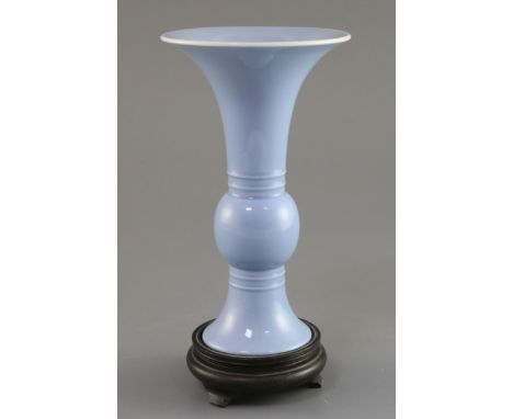 A Chinese clair de lune trumpet vase, gu, Qing dynasty, finely potted, with white glazed rim, the central bulb flanked by a p