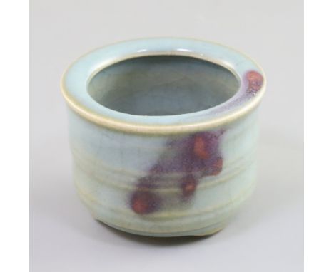 A Chinese Jun-type tripod censer, with ring turned cylindrical body, with and unglazed ring and three shaped feet, D. 7cm