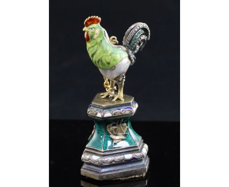 An Austro-Hungarian style baroque pearl, rose diamond and emerald set model of a cockerel, now on silver and enamel stand, ov