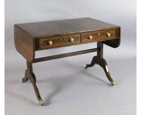 A Regency boxwood strung rosewood sofa table, with two frieze drawers, on end standards with downswept legs, fitted brass cap