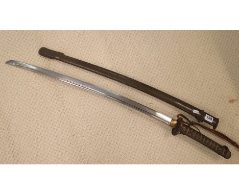 A WW2 Japanese sword in metal scabbard, shagreen and patinated handle, signed to the hilt