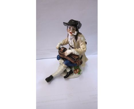 A 19th century Meissen porcelain figure of a man smoking a pipe and playing the Hurdy-Gurdy, cross swords mark to base, No 61