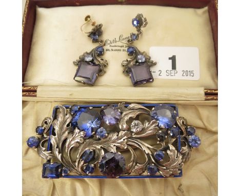 Edith Inneil, circa 1925, a silver arts and crafts brooch of foliate design with a blue enamel square frame and set with sapp