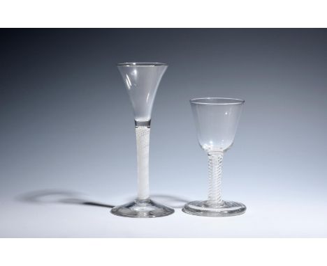 Two wine glasses  c.1750-60, one with a drawn trumpet bowl raised on a dense opaque twist stem, the other with a round funnel