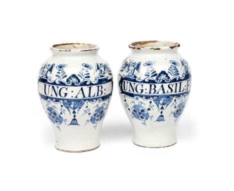 A pair of Lambeth delftware drug jars c.1730-40, the baluster forms inscribed in blue for 'Ung: Basil:FL' and 'Ung: Alb', wit
