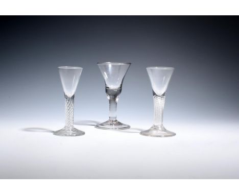 Three small drinking glasses  c.1760-70, one with a bell bowl over a plain stem and folded foot, two with small drawn trumpet