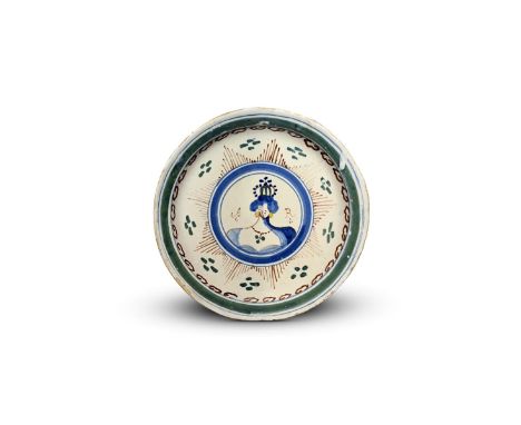 A rare Lambeth delftware Royal plate  c.1704-10, painted with a central portrait roundel of Queen Anne within a 'Star and Gar