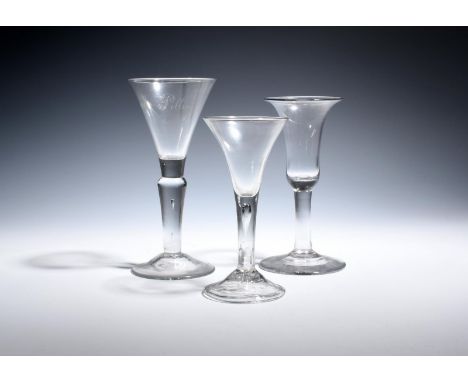 Three large wine glasses  c.1750-80, the largest with a trumpet bowl engraved in diamond point with 'J M Pilling', over a swo