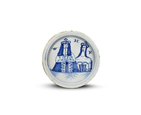 A London delftware plate of William and Mary  c.1690, the shallow form painted in blue with head and shoulder portraits of th