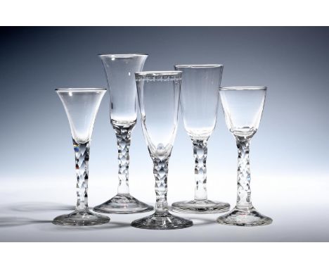 Three ale and two wine glasses  c.1770, with round funnel, bell and drawn trumpet bowls, all raised on faceted stems above fl