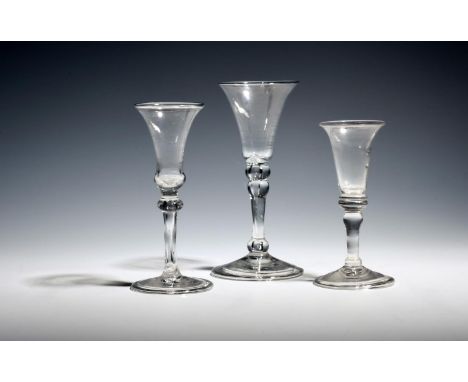 Two small gin glasses  c.1730, one soda, with bell bowls over balustroid stems and folded feet, and a larger gin glass with b