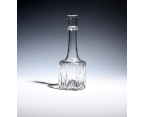 A small cruciform carafe or stopperless decanter c.1740, the long tapering neck applied with an annulated neck ring, 22.8cm.