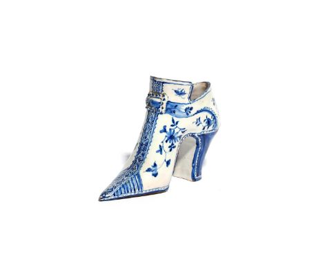 A rare delftware shoe  c.1740, probably London, painted in blue with flower sprays flanking central brocade work linked by a 