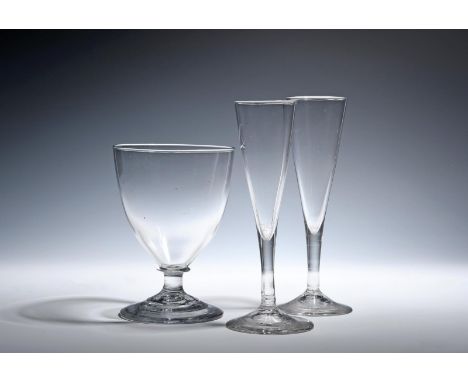 A pair of tall ale flutes  c.1780, the slender drawn trumpet bowls rising from plain stems above conical feet, and a large la