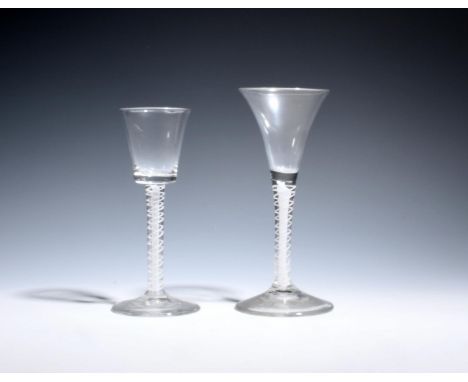 Two wine glasses  c.1760, one with a drawn trumpet bowl, the other with a bucket bowl, both over double series opaque twist s