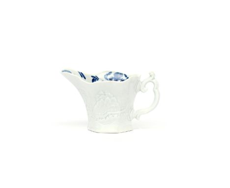 A Worcester blue and white 'Wigornia' creamboat  c.1753-55, the shaped hexagonal form moulded in relief with a Chinese landsc
