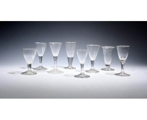 Seven small English and Continental wine glasses  18th century, with drawn trumpet bowls over plain stems and conical or fold