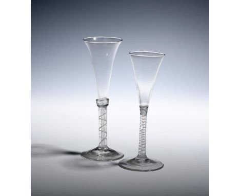 Two wine glasses or flutes  c.1760, with slender drawn trumpet bowls, one with an annulated collar above a mixed twist stem, 