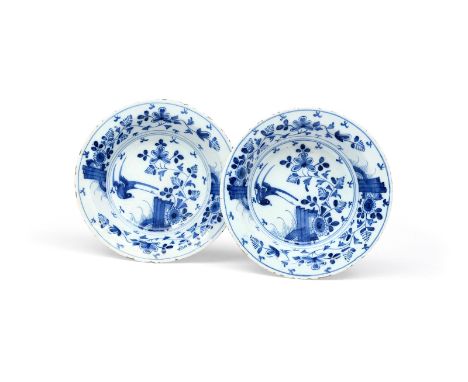 A pair of delftware shallow bowls  c.1760-70, each painted in blue with a bird in flight above flowering branches, some rim f