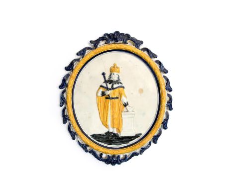 A Pratt ware plaque of Charles I  c.1800, standing with one hand resting on a square pillar, wearing ceremonial robes and hol