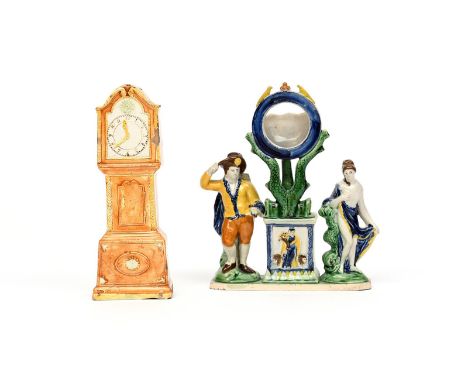 A Pratt ware pocket watch stand  c.1800, the watch support surmounted on the tails of two dolphins above a plinth moulded wit