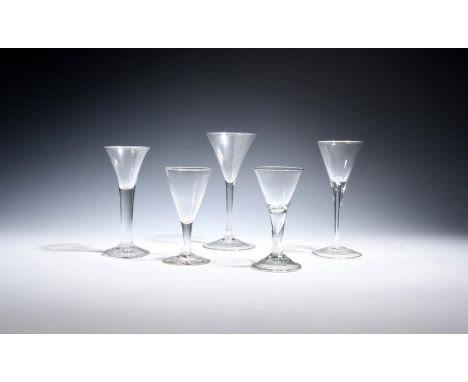 Five wine glasses  c.1750-60, with drawn trumpet bowls, one a toasting glass raised on a slender plain stem, one soda glass r