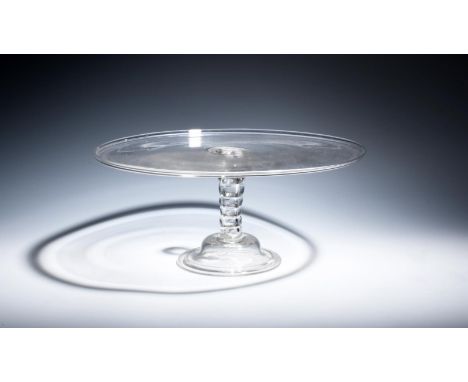A large glass tazza  c.1740, the wide circular top with a galleried rim, raised on a bobbin stem with seven shallow knops, ab
